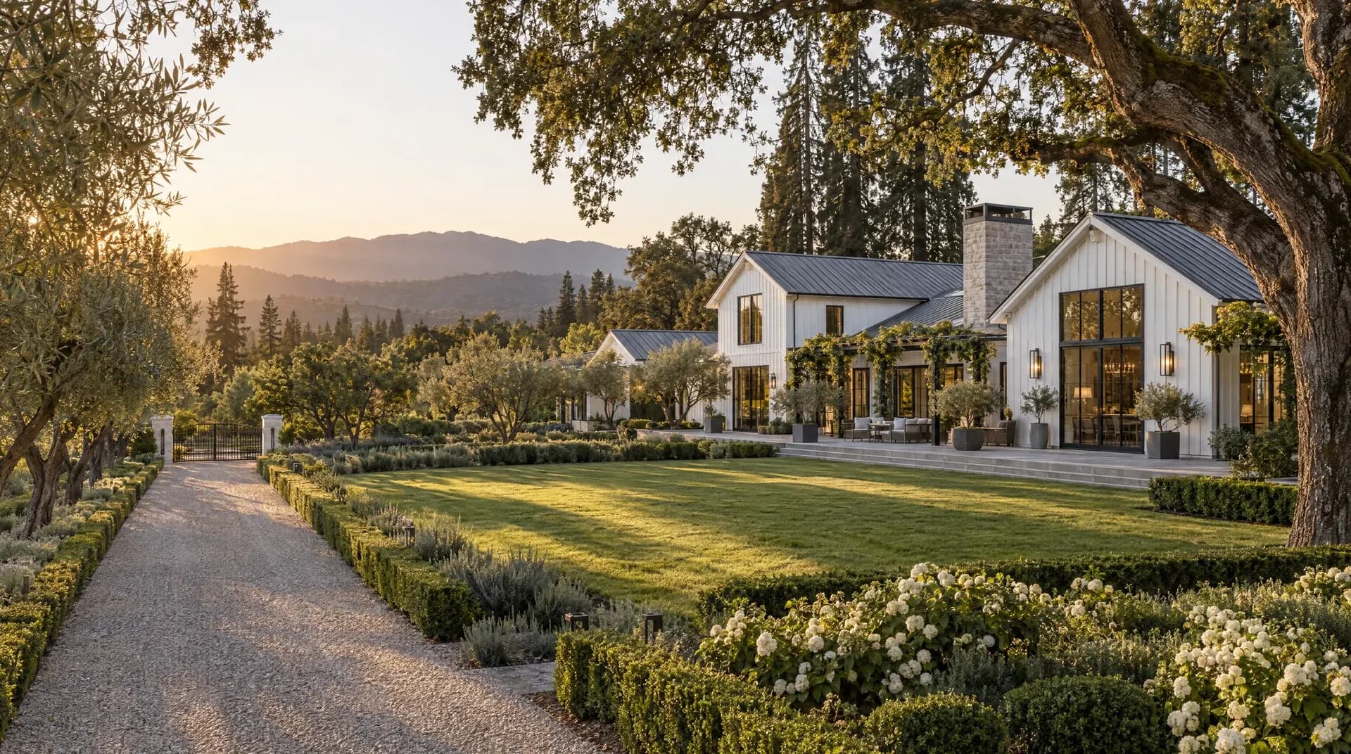 Modern farmhouse estate in Atherton, California, framed by heritage oaks at golden hour